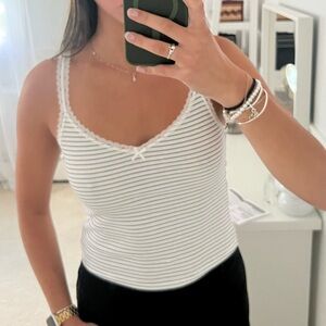 Black and white striped tank top with lace trim and bow.